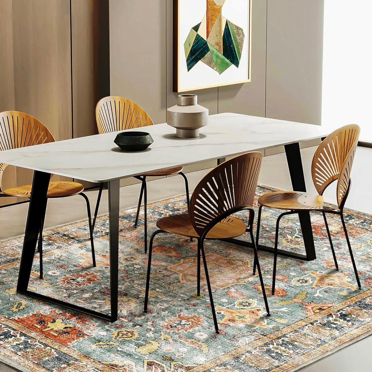 Blue Moroccan floral boho area rug under a marble dining table with fan-back wooden chairs.